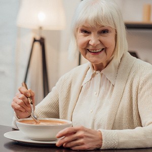 A woman eating soup