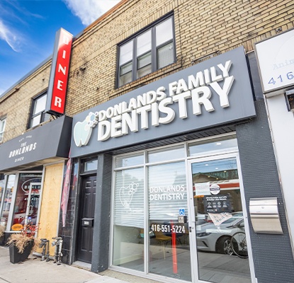 Woman in dental chair smiling at dentist