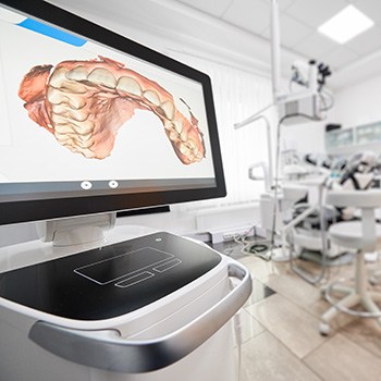 a chairside monitor with an impression of a mouth on the screen