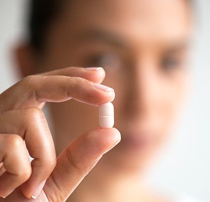 Hand holding a sedative pill