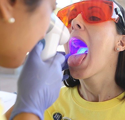 Woman receiving oral cancer screening