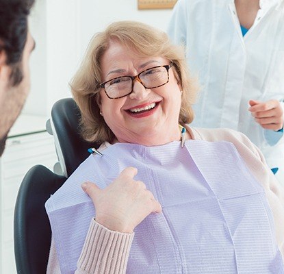 Laughing older woman in dental chair