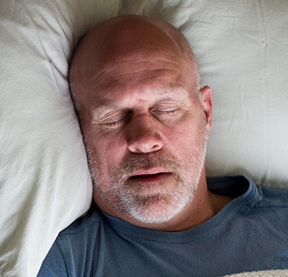 Man sleeping soundly in bed