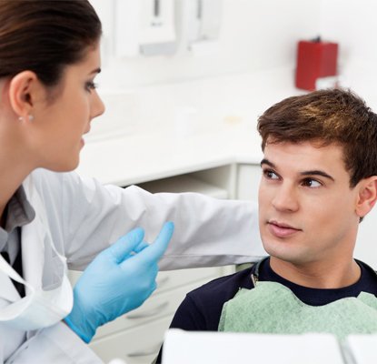 A dentist talking to a young man