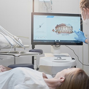 Dental assistant using Itero software to scan patient's teeth