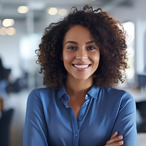 Woman in blue shirt smiling at office
