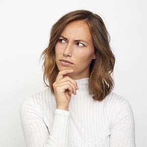 woman wondering whether extracting the tooth would be cheaper