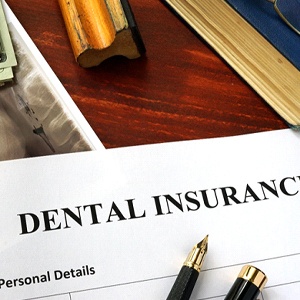 Dental insurance paperwork on wooden desk
