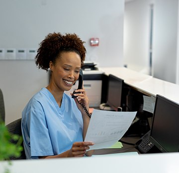 a front desk worker contacting a patient over the phone
