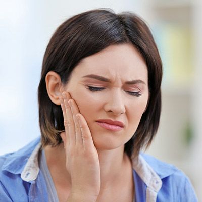 Woman holding jaw