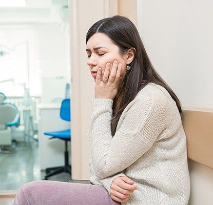 Woman in pain holding jaw