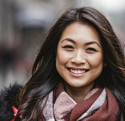 person smiling on a city street
