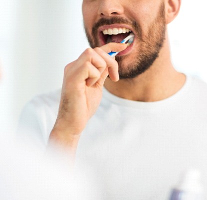 person brushing their teeth