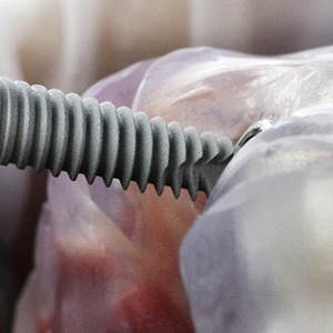 Close-up of dental implant being placed into model
