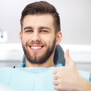 Smiling patient, happy he could save money with dental implants