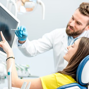 East York dentist explaining X-ray to smiling patient