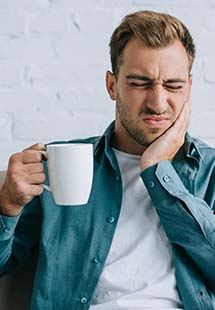 man holding jaw in pain