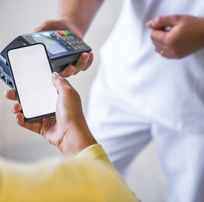 Person using phone to pay for dental treatment