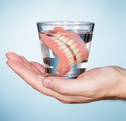 Full dentures in glass of water