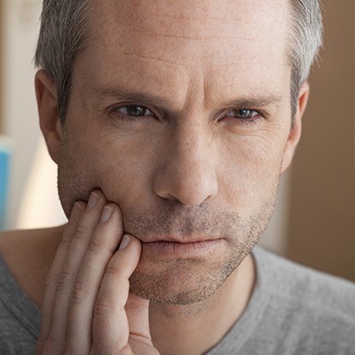 Man in pain holding jaw