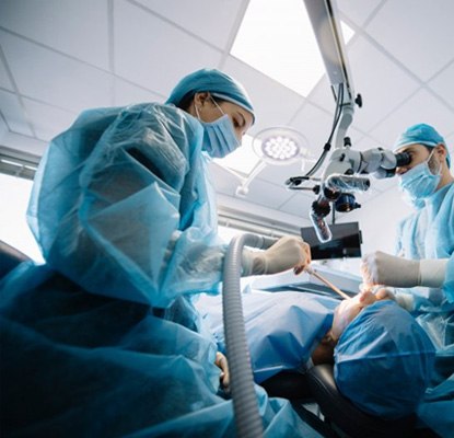 an oral surgeon performing dental implant placement surgery