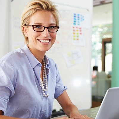 Smiling tem member with laptop