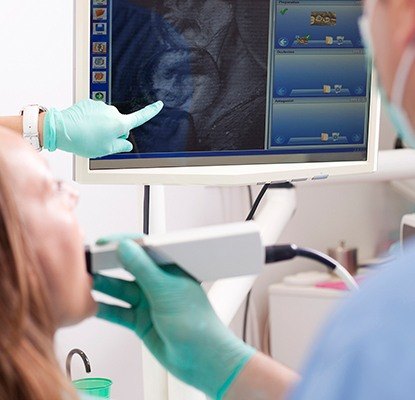 Dentist and patient looking at intraoral images