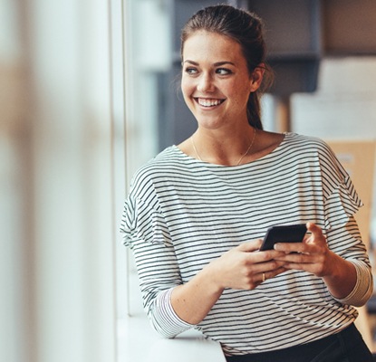 person smiling while on their phone