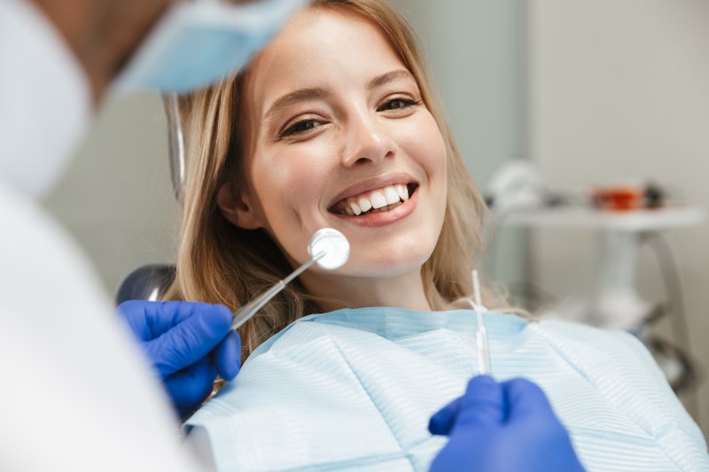 Woman smiling at routine dentist appointment