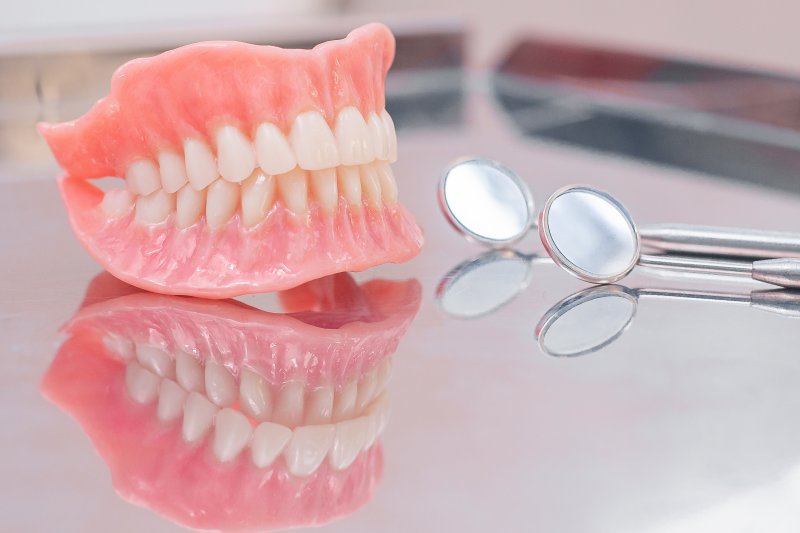 Two dentures sitting on a desk