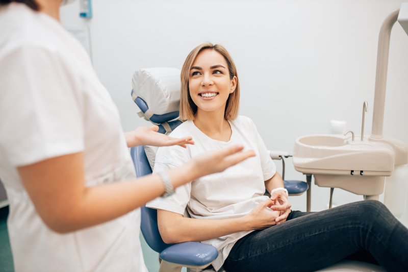 A dentist explaining the relationship between gum disease and exercise