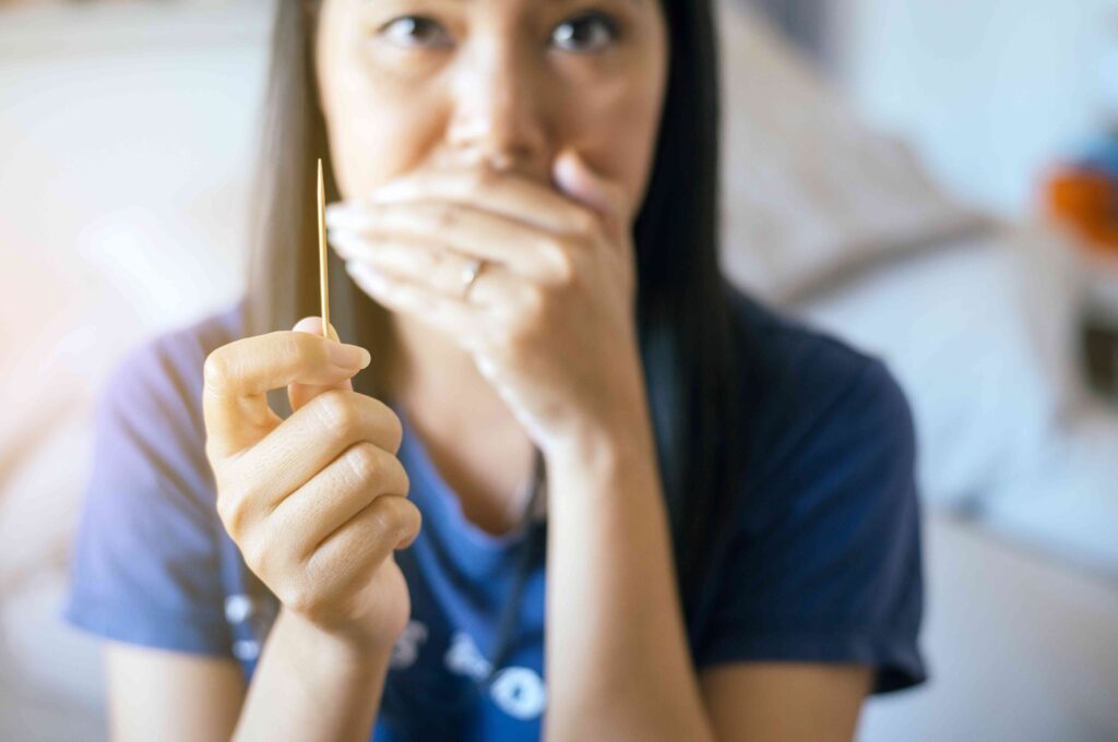 Woman holding a toothpick