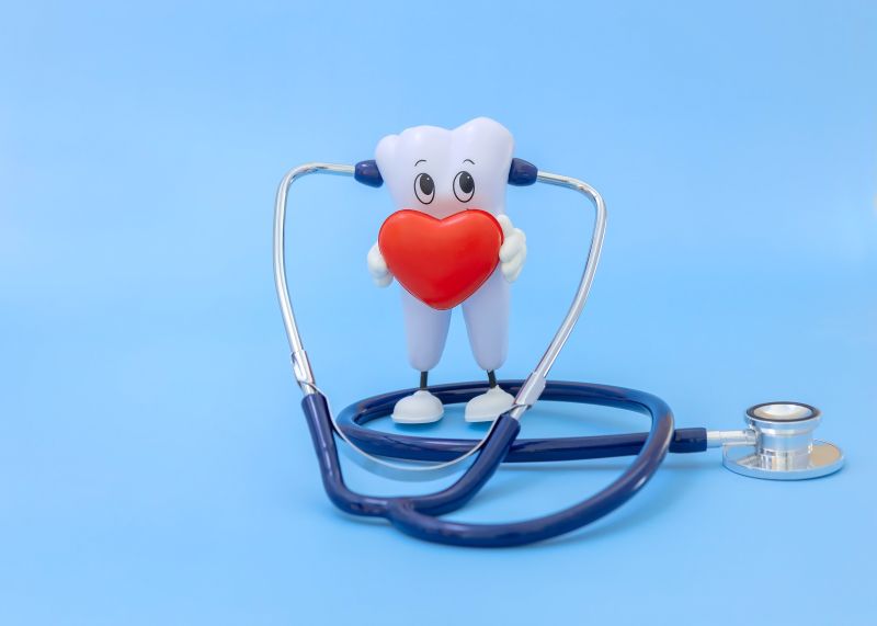 A CGI of a tooth wearing a stethoscope and holding a heart